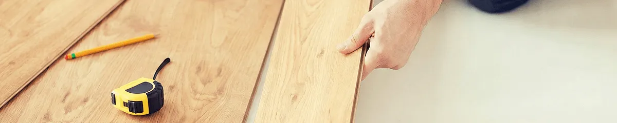 A professional installing wood flooring in Irvine, CA