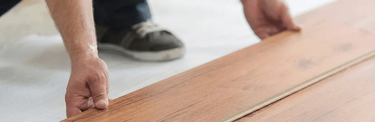 A professional installing laminate flooring in Irvine, CA